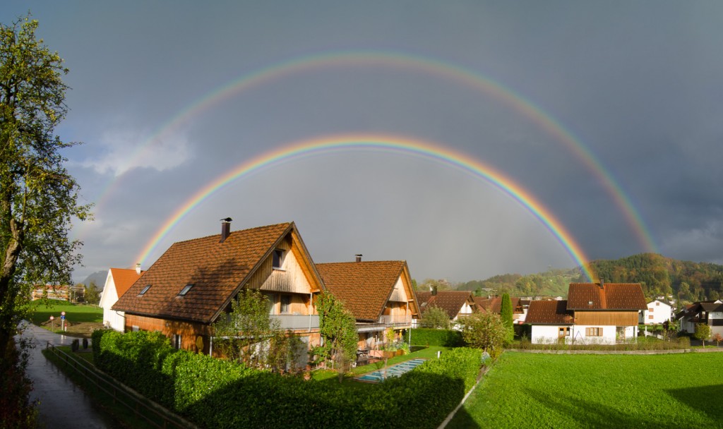 Panoramic image of a very bright double rainbow.