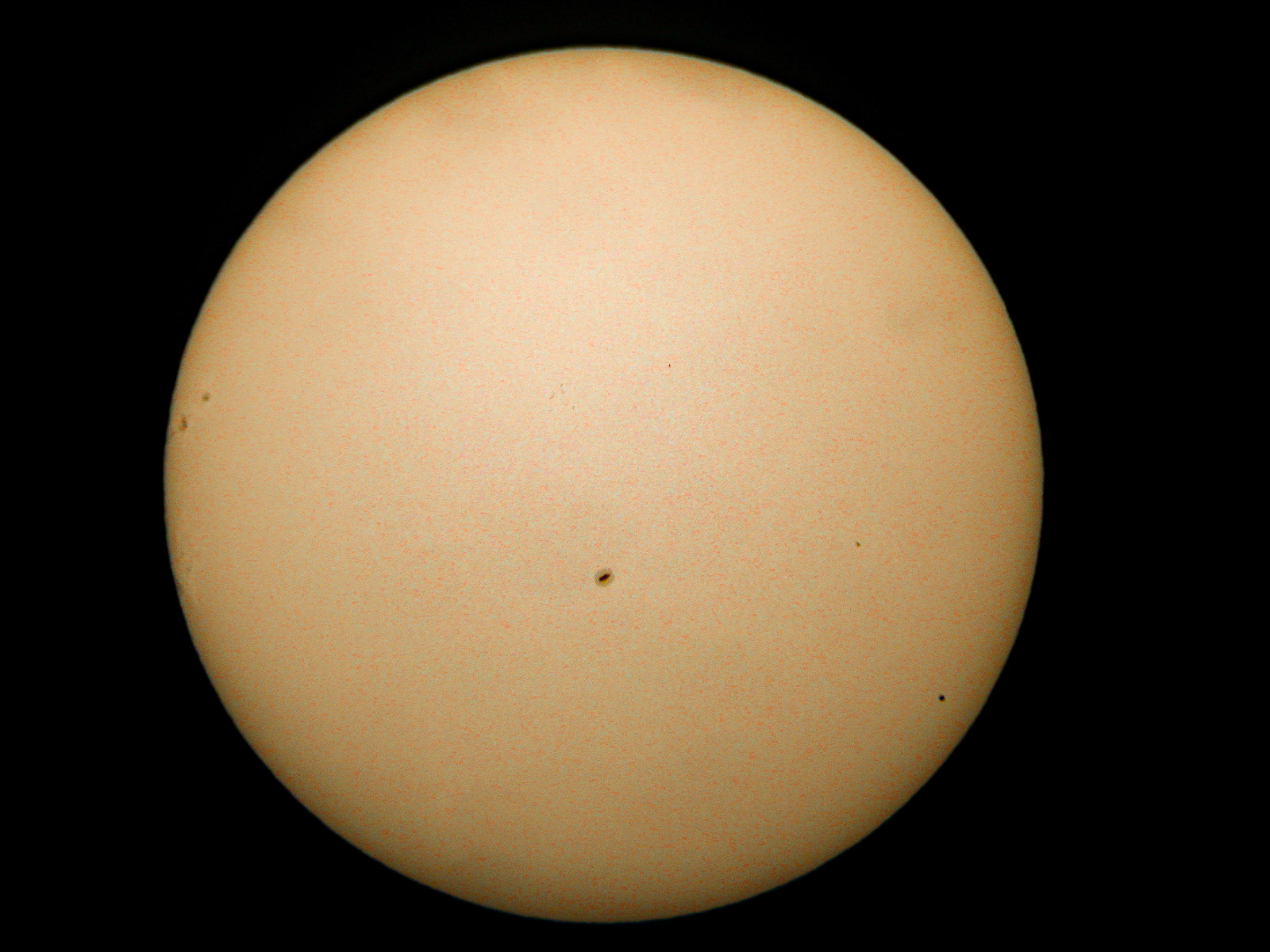 Solar disc with Mercury on the lower right.